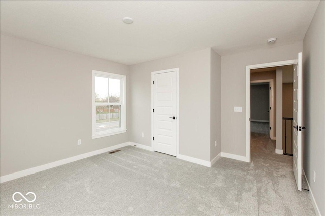 6973 Oakdale Ln, Avon, IN 46123 - unfurnished bedroom with visible vents, baseboards, and light colored carpet