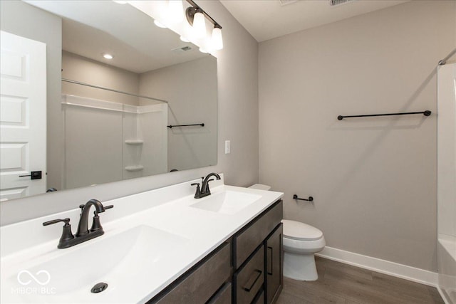 6973 Oakdale Ln, Avon, IN 46123 - bathroom featuring baseboards, a sink, toilet, and wood finished floors