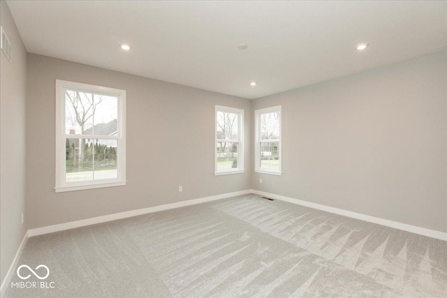 6973 Oakdale Ln, Avon, IN 46123 - unfurnished room featuring baseboards, recessed lighting, a wealth of natural light, and light carpet