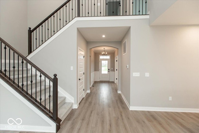 6973 Oakdale Ln, Avon, IN 46123 - foyer entrance featuring arched walkways, wood finished floors, visible vents, and stairs