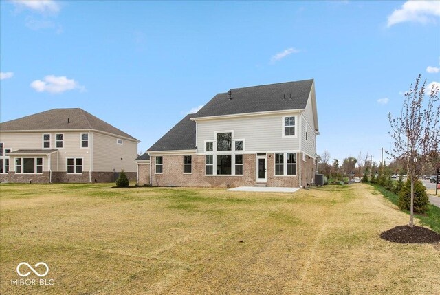 6973 Oakdale Ln, Avon, IN 46123 - rear view of property featuring cooling unit, a yard, a patio area, and brick siding