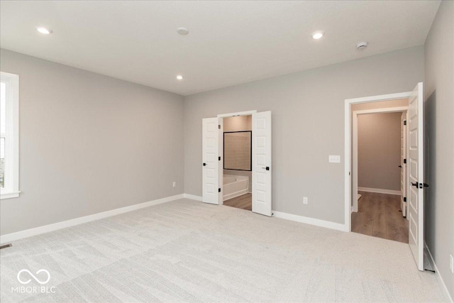 6973 Oakdale Ln, Avon, IN 46123 - unfurnished bedroom featuring carpet flooring, baseboards, connected bathroom, and recessed lighting