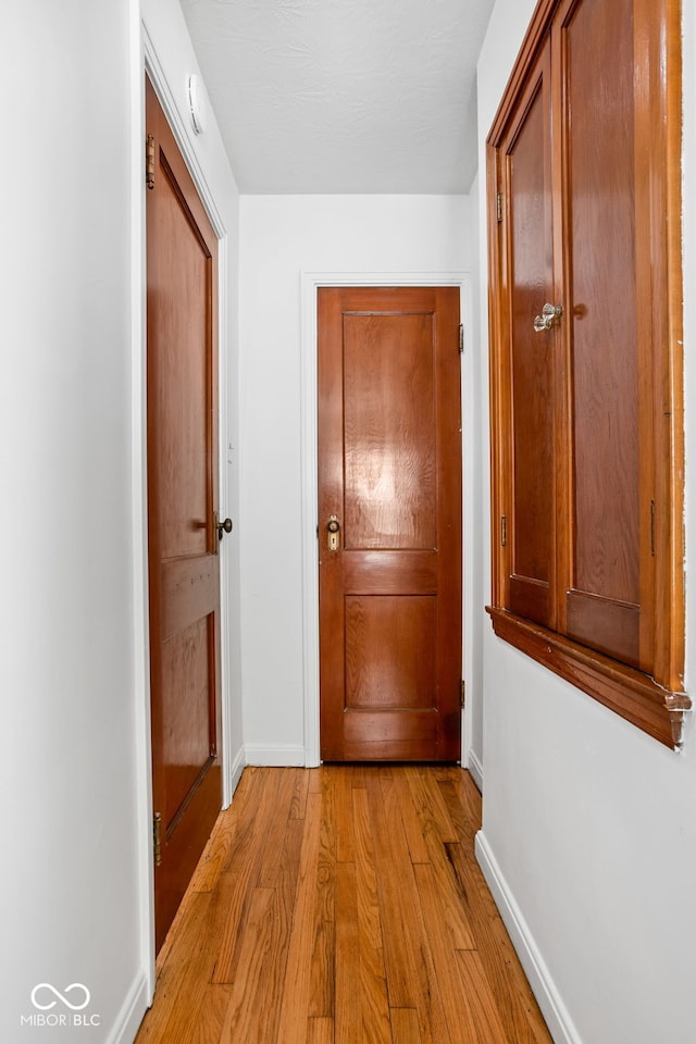 corridor featuring light hardwood / wood-style floors