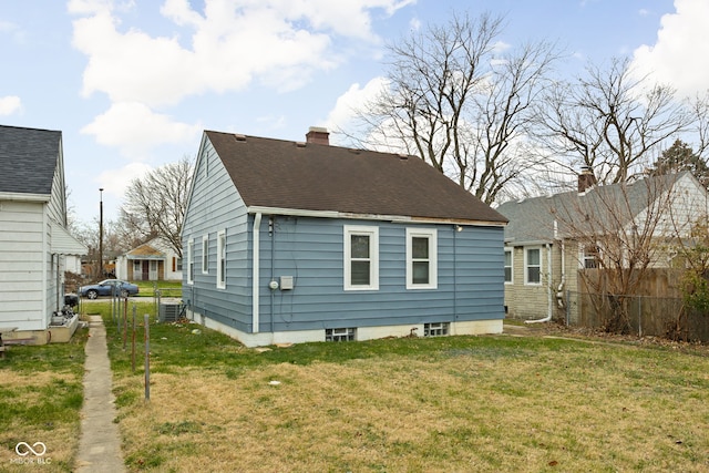 back of property featuring a lawn