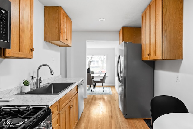 kitchen featuring sink, stainless steel appliances, and light hardwood / wood-style floors