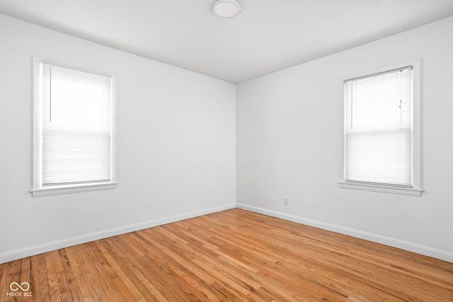 empty room with light hardwood / wood-style flooring