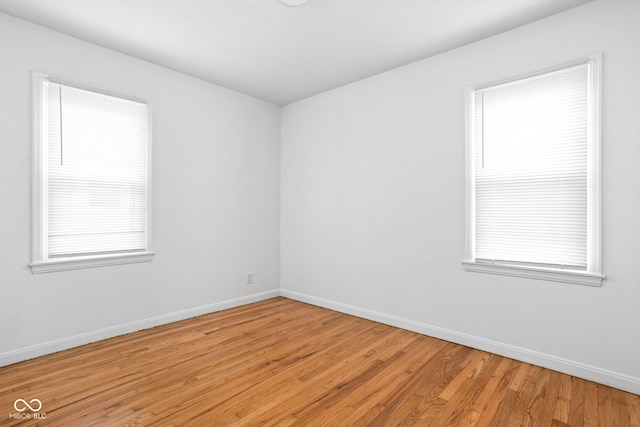 unfurnished room with light hardwood / wood-style flooring