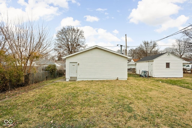 exterior space featuring an outdoor structure and a yard