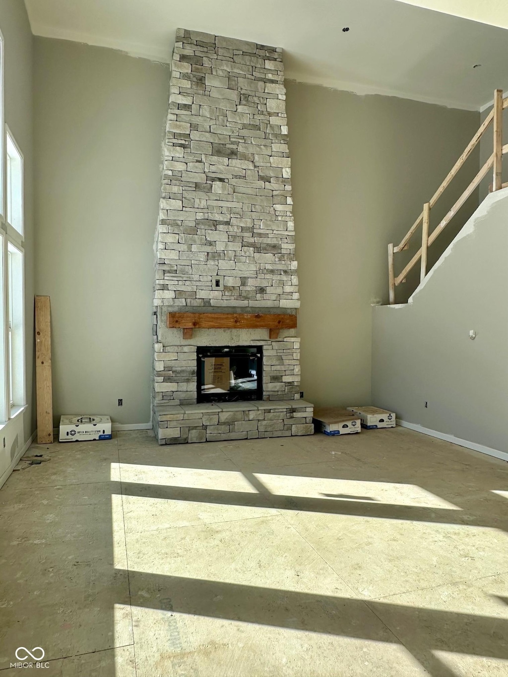 unfurnished living room with a stone fireplace