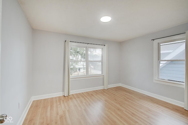 unfurnished room with light wood-type flooring