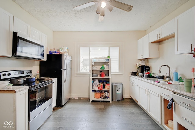 kitchen featuring sink, stainless steel appliances, dark hardwood / wood-style floors, and white cabinets