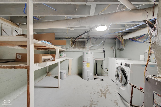 basement featuring electric water heater and washer and dryer