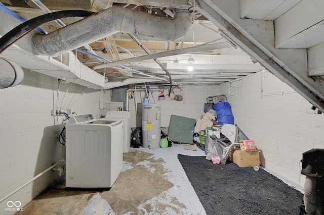 basement featuring electric water heater and independent washer and dryer