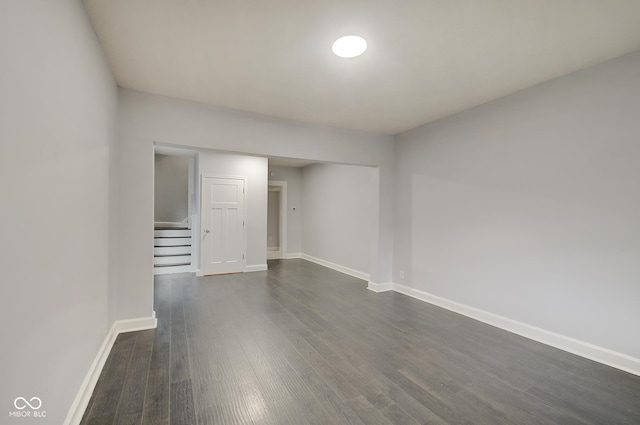 empty room with dark hardwood / wood-style flooring