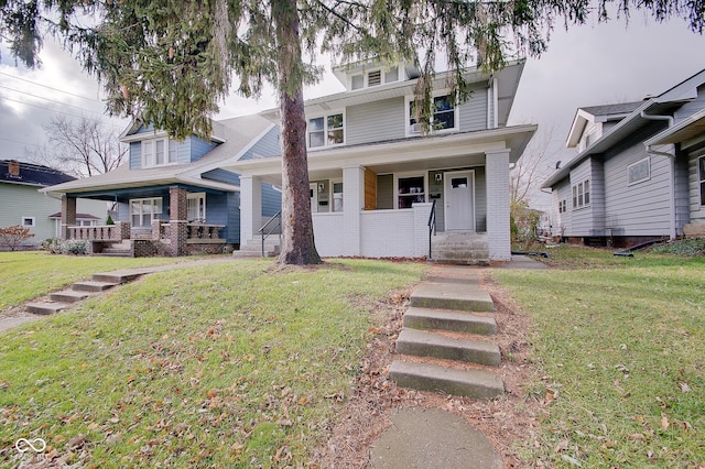 view of front of house with a porch and a front yard