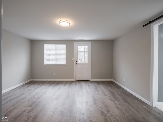 interior space with hardwood / wood-style floors and a barn door