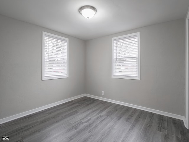 empty room featuring dark hardwood / wood-style floors and plenty of natural light