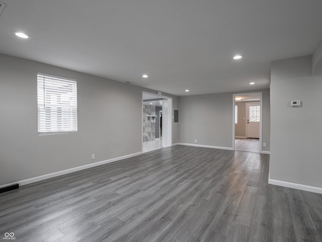 unfurnished living room with dark hardwood / wood-style floors and a fireplace