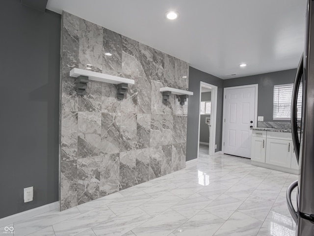 entrance foyer featuring tile walls