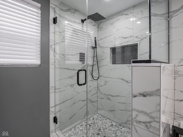 bathroom with a shower with door