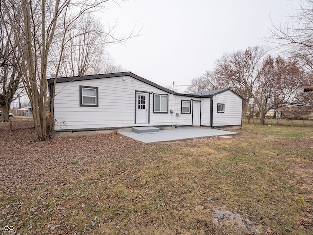 rear view of property with a lawn and a patio area