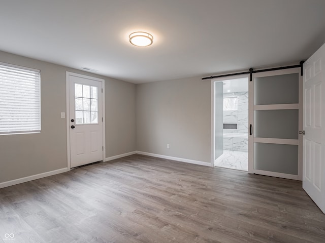 interior space with hardwood / wood-style floors and a barn door