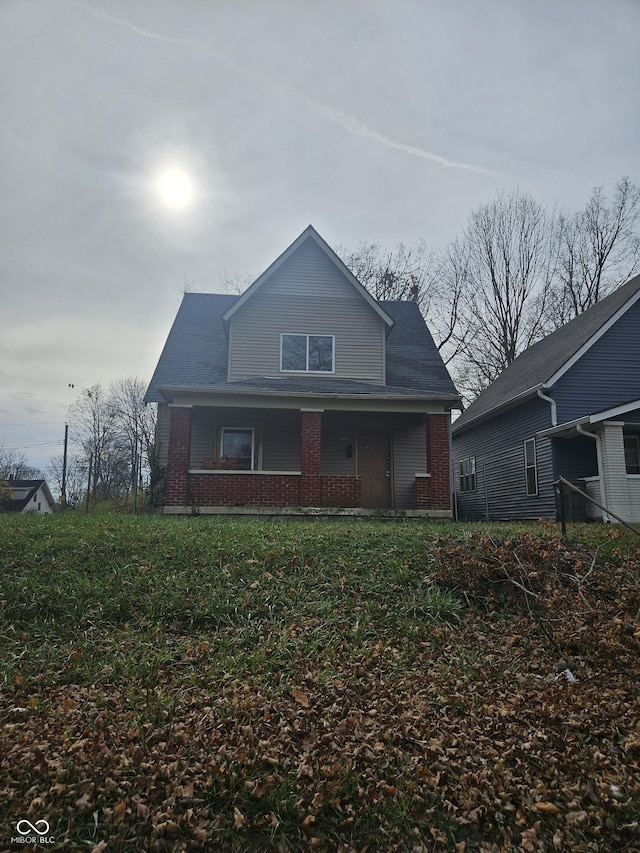 1207 W 35th St, Indianapolis, IN 46208 - view of front facade featuring brick siding and a porch