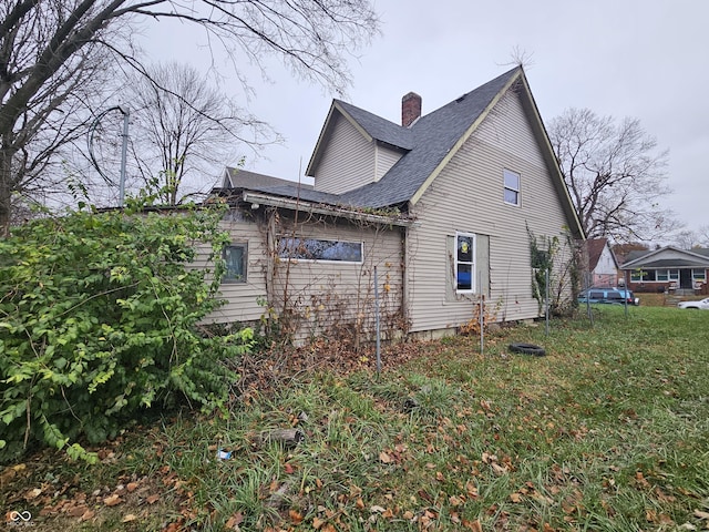 view of side of property with a lawn