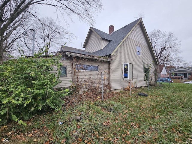 1207 W 35th St, Indianapolis, IN 46208 - view of side of property featuring a chimney and roof with shingles