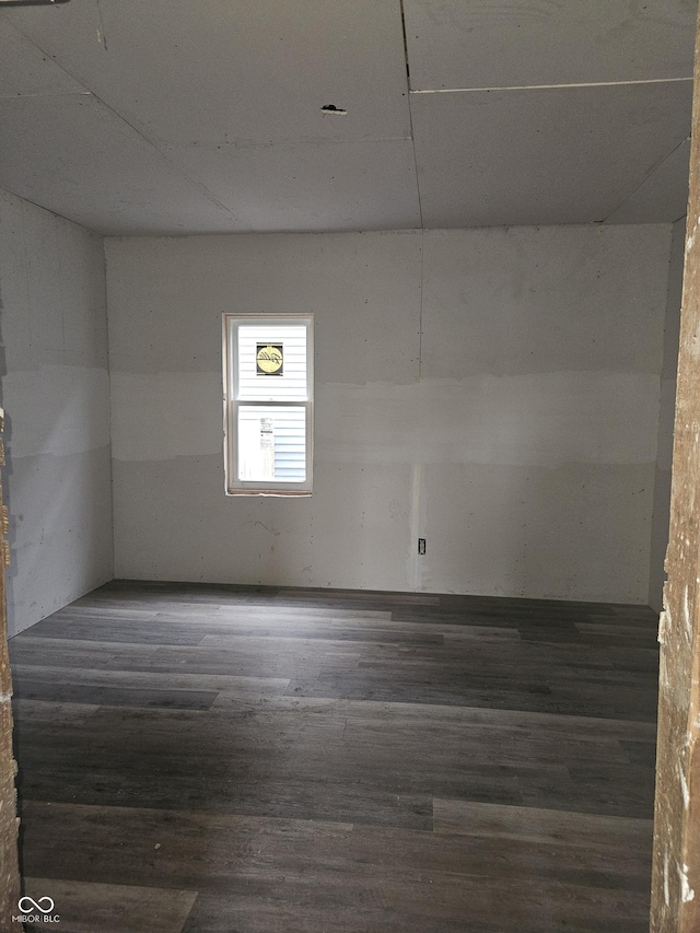 empty room featuring dark hardwood / wood-style flooring