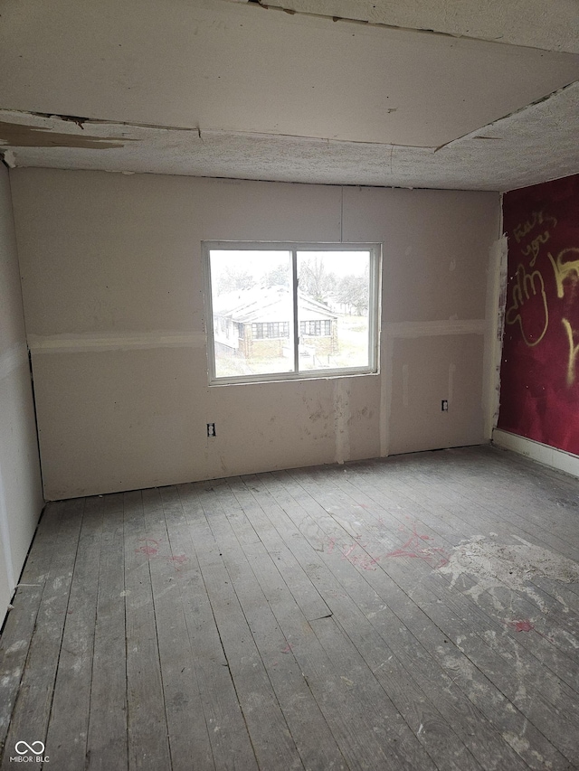 spare room featuring hardwood / wood-style flooring