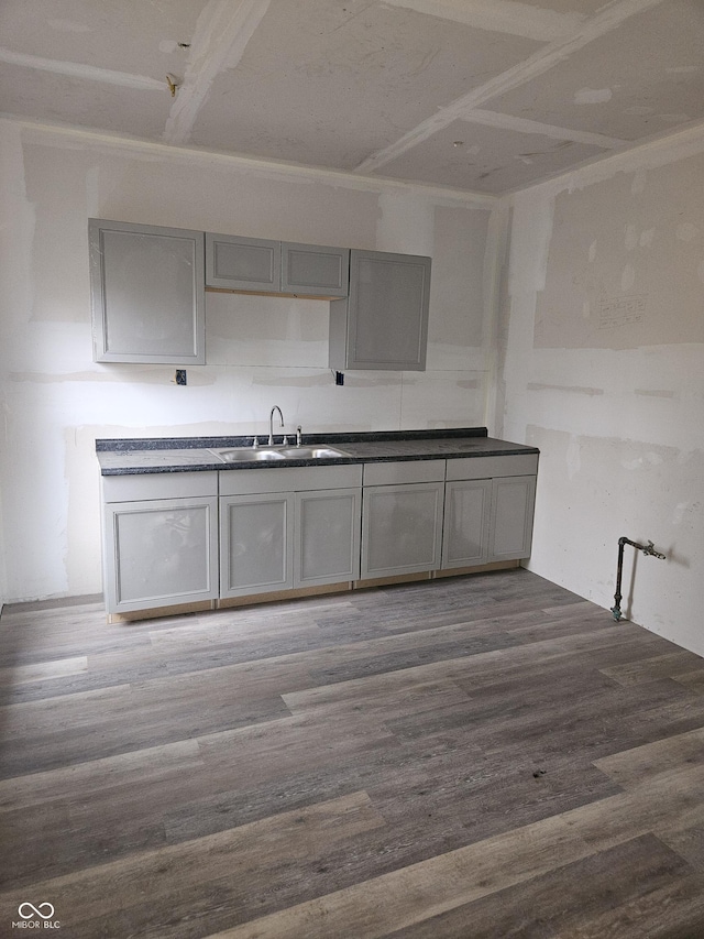 1207 W 35th St, Indianapolis, IN 46208 - kitchen featuring gray cabinets, wood finished floors, and dark countertops
