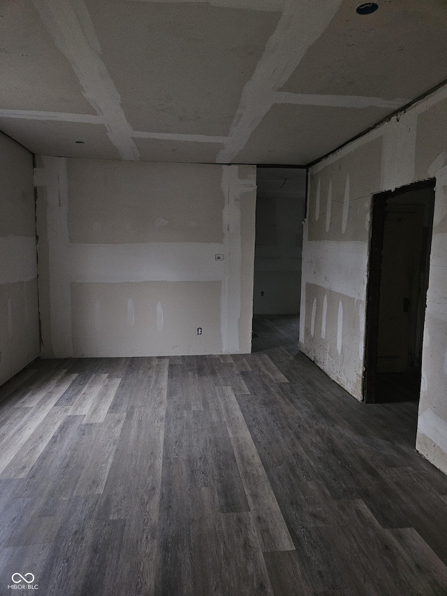 unfurnished room with dark wood-type flooring