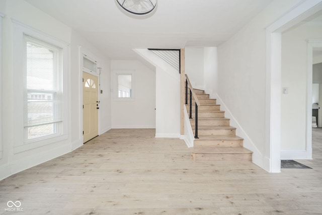 entryway with light hardwood / wood-style floors and plenty of natural light