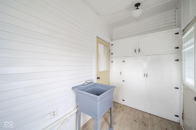 washroom featuring wood walls and light wood-type flooring