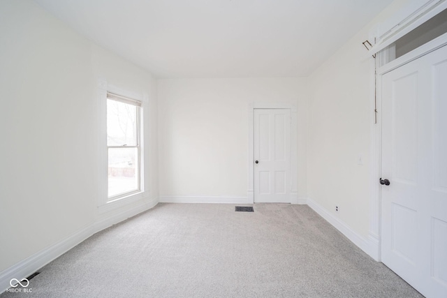 unfurnished room with light carpet