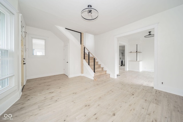 foyer with light hardwood / wood-style flooring and ceiling fan