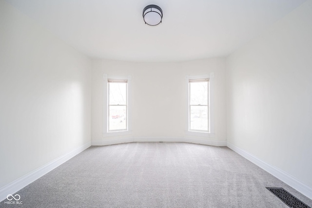 carpeted empty room with a healthy amount of sunlight