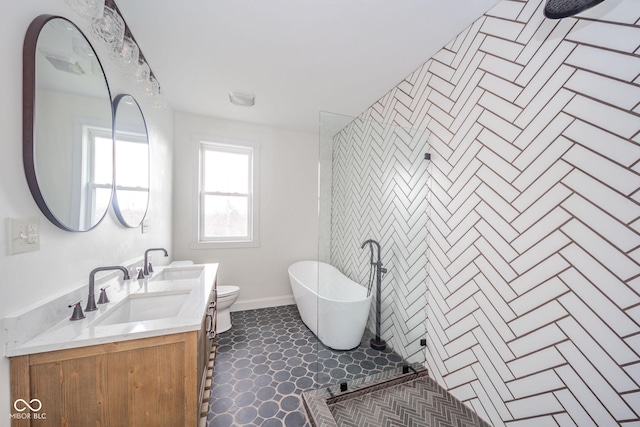 bathroom with a bathtub, vanity, and toilet