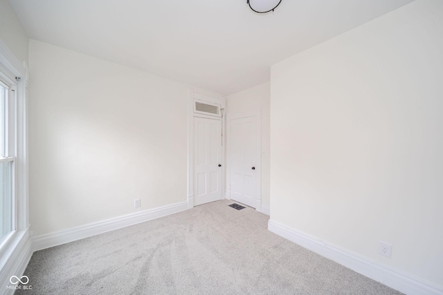 empty room with light colored carpet