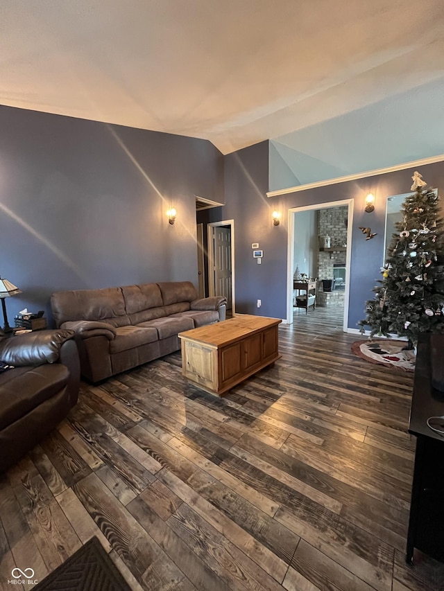 living room featuring dark hardwood / wood-style flooring and high vaulted ceiling