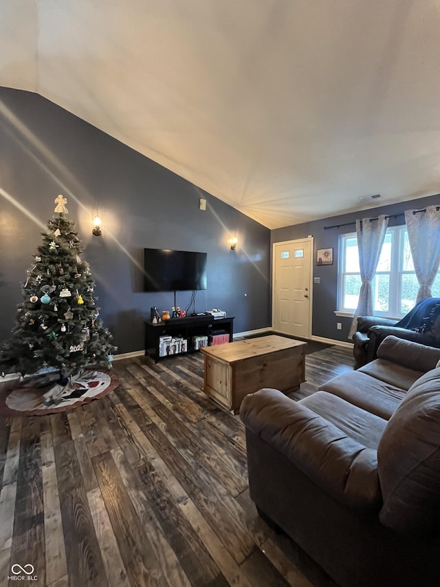 living room with dark hardwood / wood-style floors and lofted ceiling