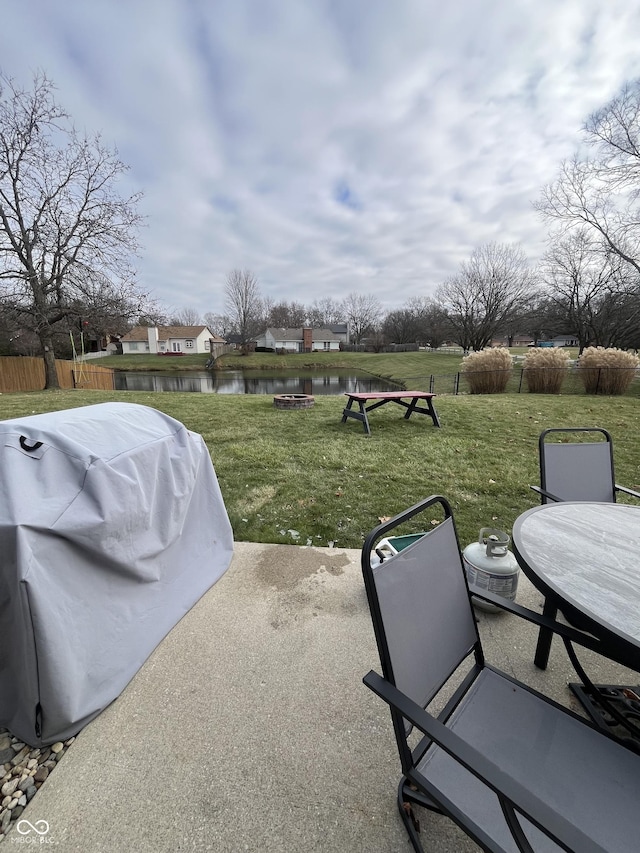 view of patio / terrace with a water view and a grill