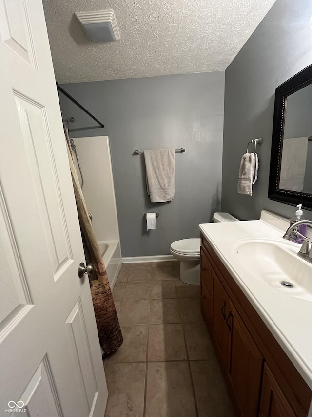 full bathroom featuring tile patterned flooring,  shower combination, a textured ceiling, toilet, and vanity