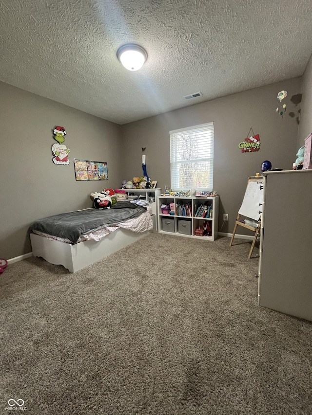 carpeted bedroom with a textured ceiling