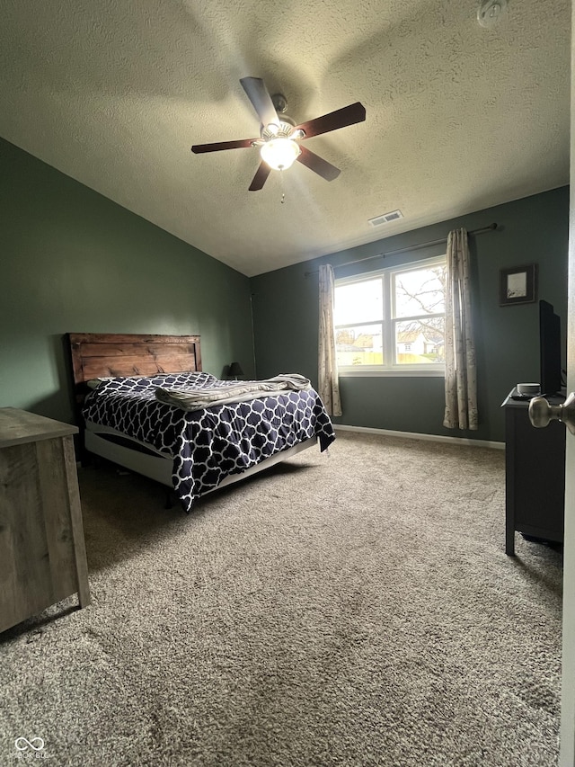 carpeted bedroom featuring a textured ceiling, ceiling fan, and lofted ceiling