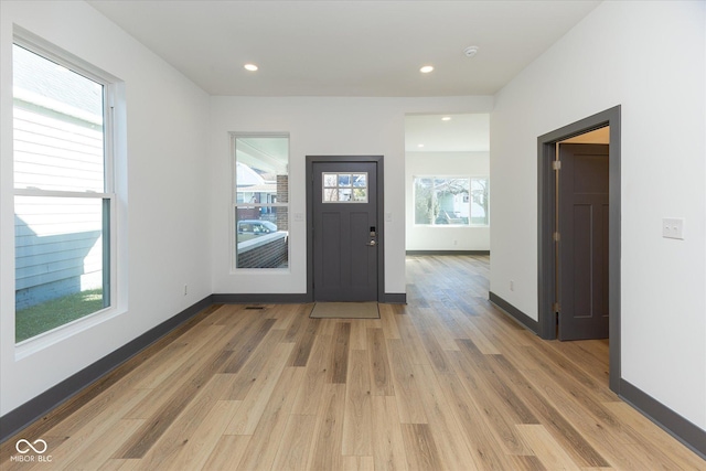 entryway with hardwood / wood-style floors and a healthy amount of sunlight