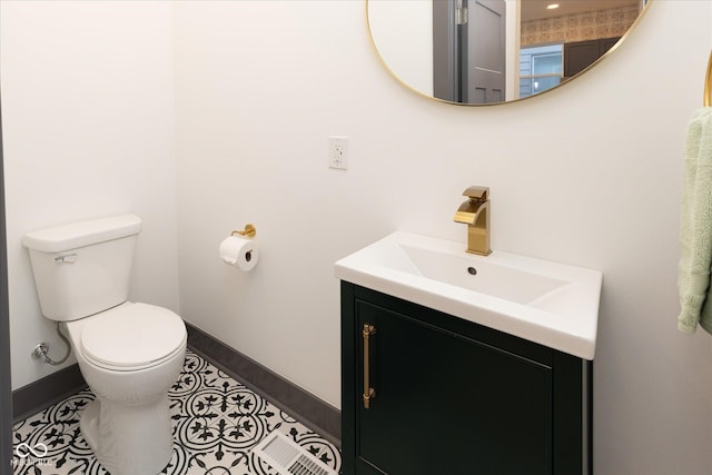 bathroom with tile patterned floors, vanity, and toilet