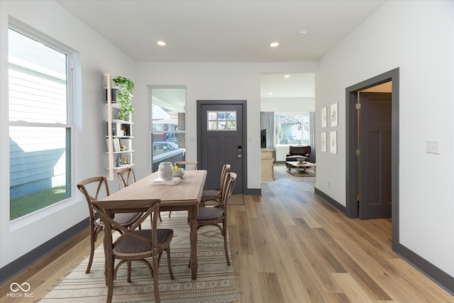 dining space with plenty of natural light and hardwood / wood-style flooring