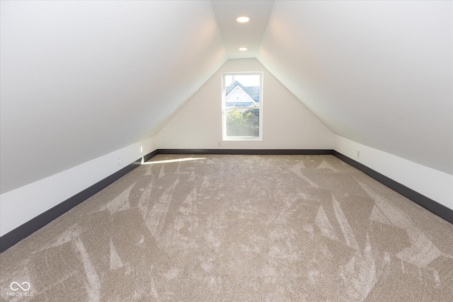 bonus room with carpet floors and lofted ceiling